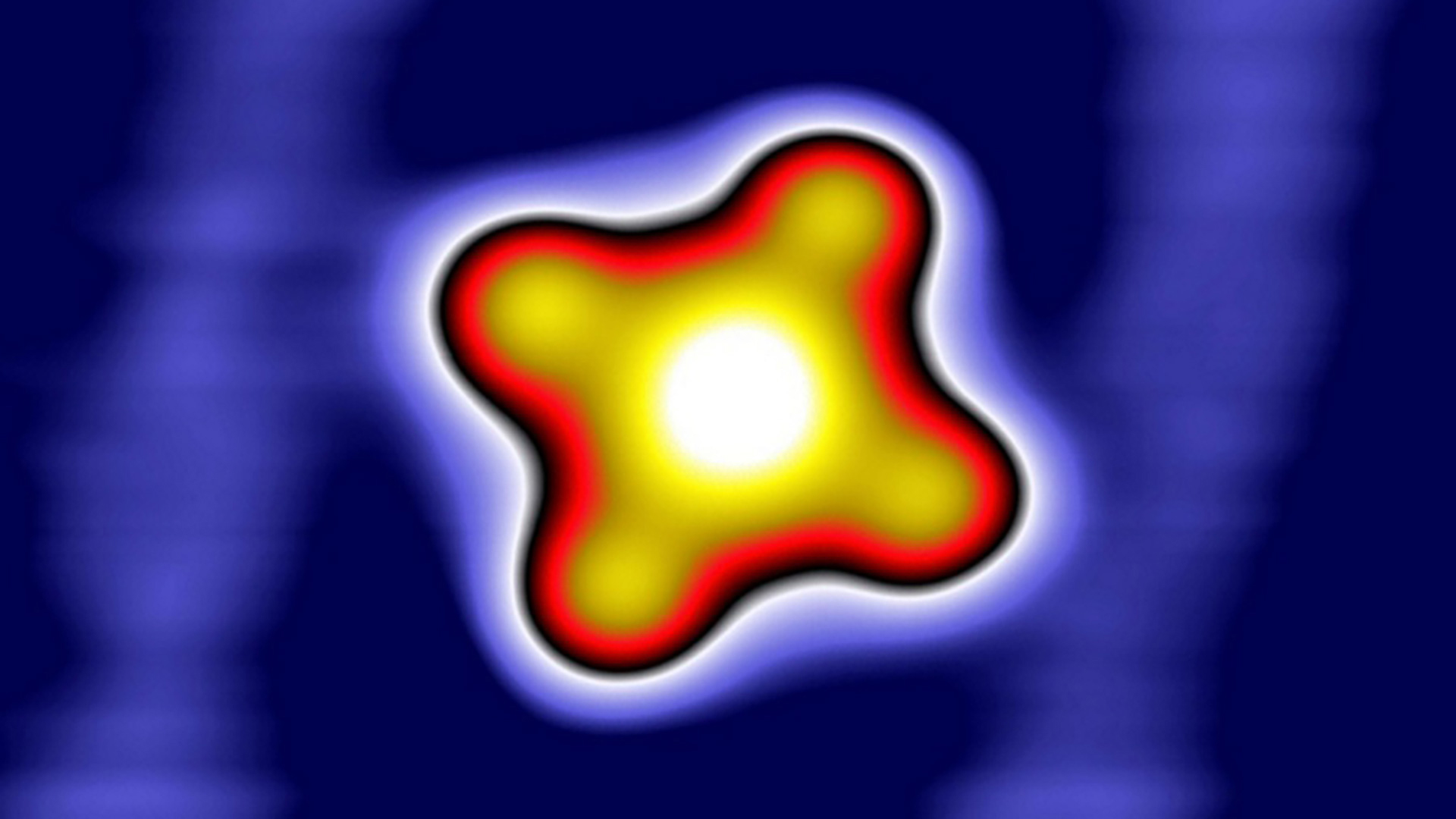 Glowing white to yellow to red to violet, rounded four-pronged shape on deep indigo background.